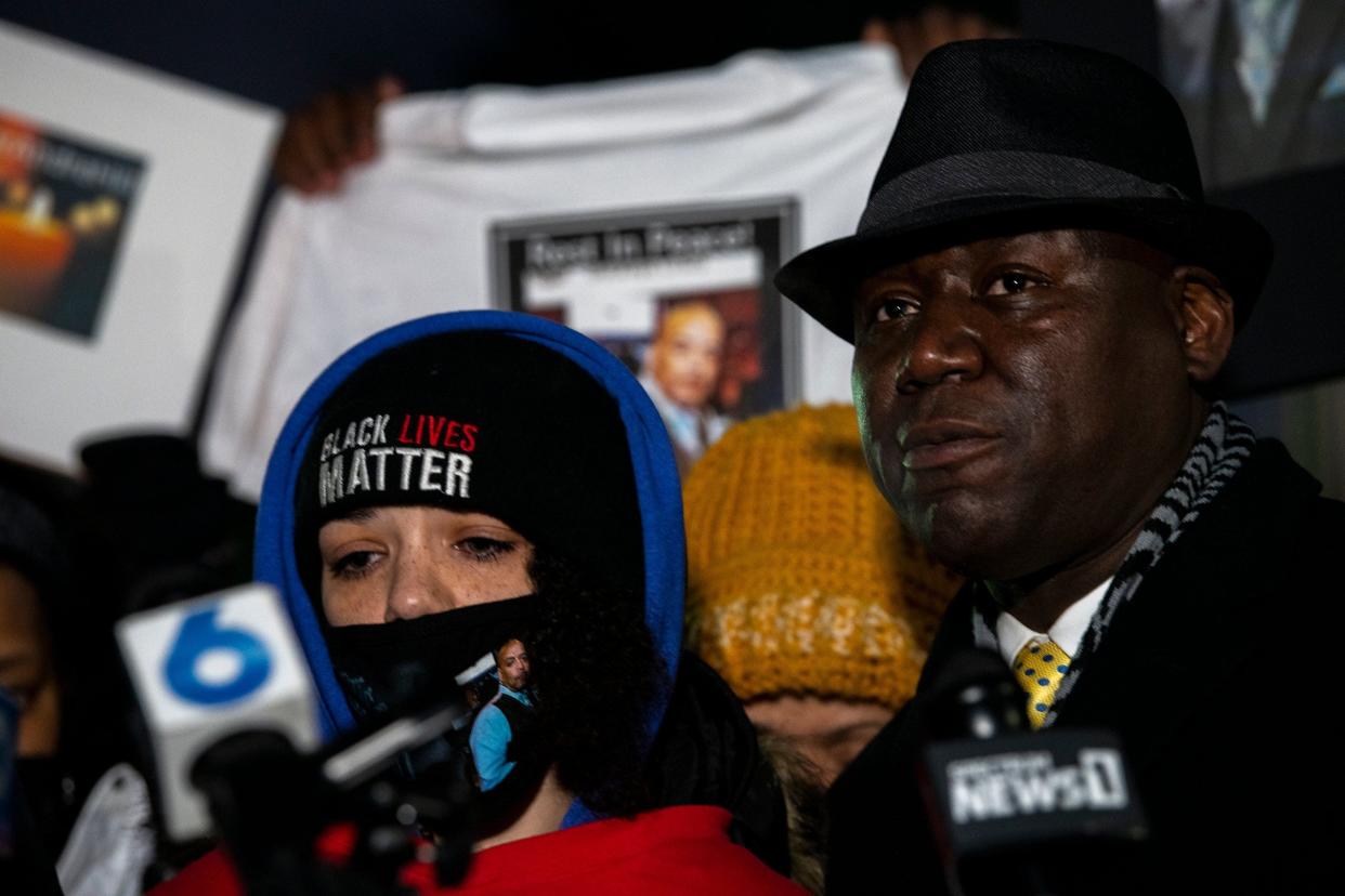 Karissa Hill, daughter of Andre Hill, an unarmed Black man who was fatally shot by a Columbus police officer, stands beside Attorney Ben Crump during a vigil for her father in December.