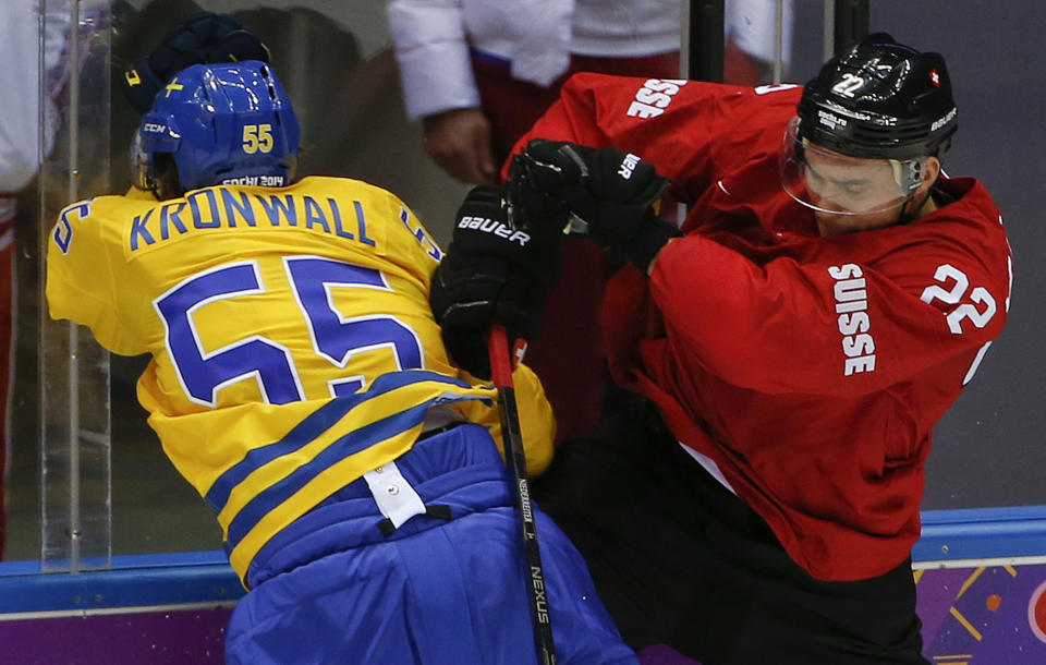 Sweden defenseman Niklas Kronwall collides with Switzerland forward Nino Niederreiter in the first period of a men's ice hockey game at the 2014 Winter Olympics, Friday, Feb. 14, 2014, in Sochi, Russia. (AP Photo/Julio Cortez)