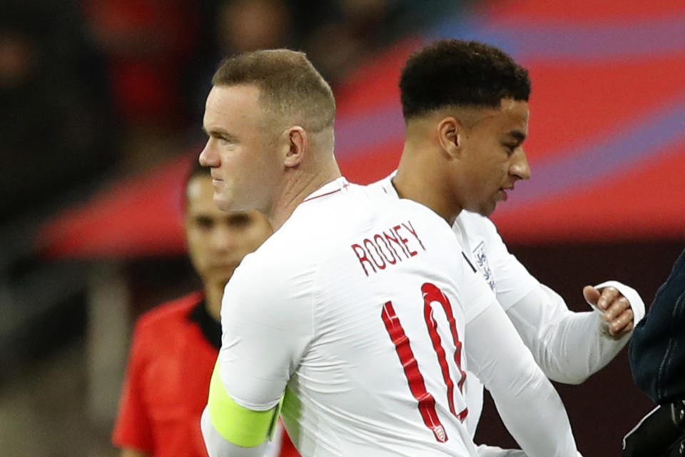 England's Wayne Rooney substitutes England's Dele Ali, right, for his 120th cap during the international friendly soccer match between England and the United States at Wembley stadium, Thursday, Nov. 15, 2018. (AP Photo/Alastair Grant)