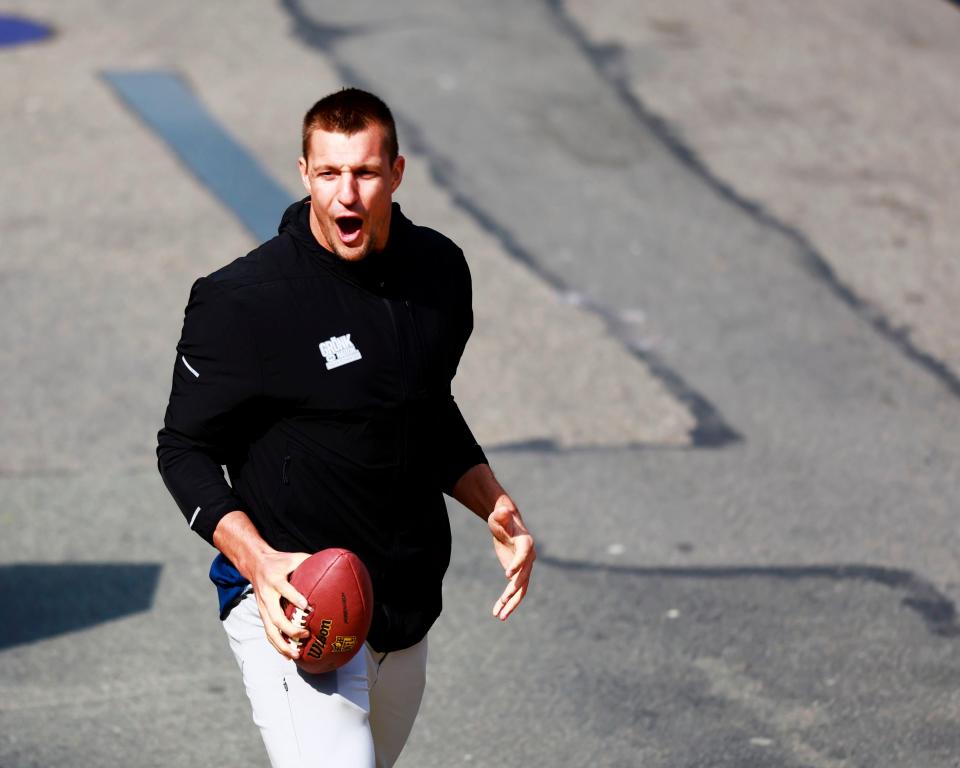 BOSTON, MASSACHUSETTS - APRIL 15: Boston Marathon Grand Marshal and former New England Patriot Rob Gronkowski shows off the winner's trophy at the finish line during the 128th Boston Marathon on April 15, 2024 in Boston, Massachusetts. (Photo by Omar Rawlings/Getty Images)