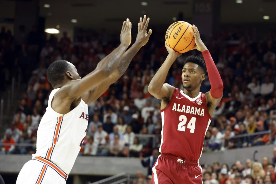 Alabama forward Brandon Miller (24) shoots over Auburn forward Jaylin Williams during the first half of an NCAA college basketball game, Saturday, Feb. 11, 2023, in Auburn, Ala. (AP Photo/Butch Dill)