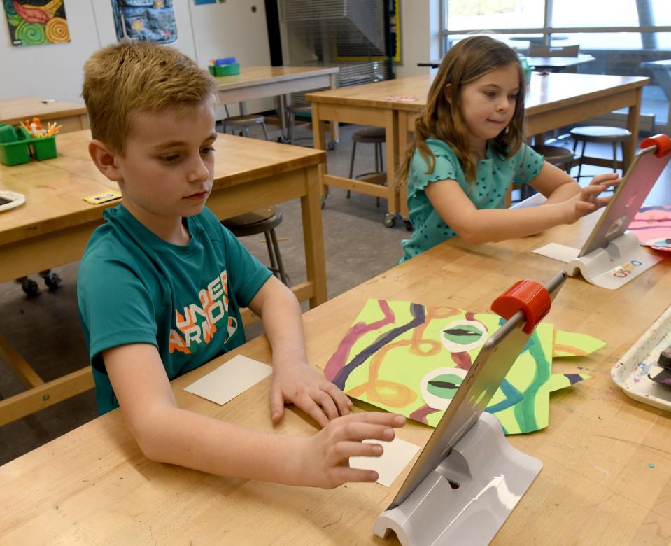 Lake Elementary second graders Logan Valentine and Joanna Pearce work on art projects on their iPads. Lake Local officials have said that art classes will be eliminated for elementary students if voters again reject the district's levy request.