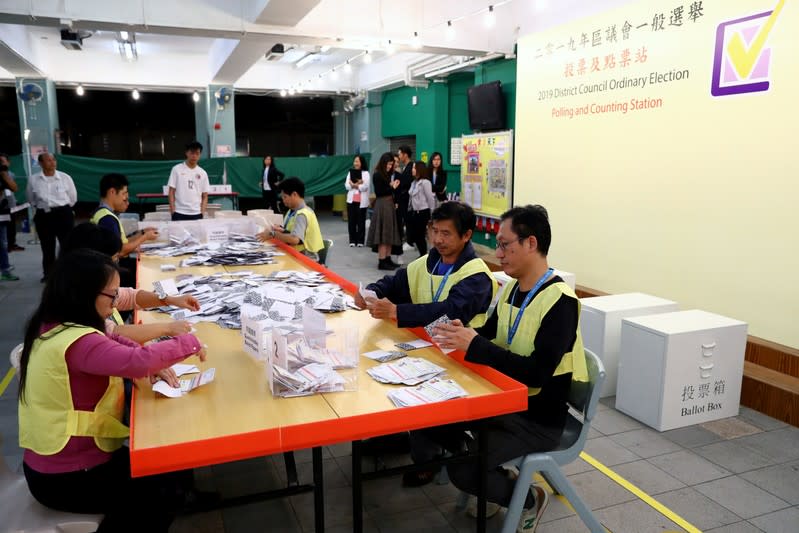 Officials count votes at a polling station in Kowloon Tong, Hong Kong