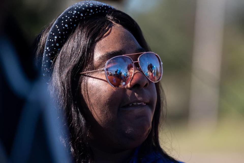 Markeia Shannon, 27, of Pascagoula, looks on as she watches a balloon release in honor of her cousin Corri Howard off of Howze Avenue in Moss Point on Monday, Jan. 17, 2022. Howard’s body was discovered in a marsh nearby after he went missing following a police chase.