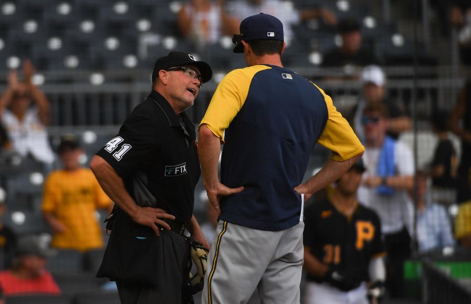 Brewers manager Craig Counsell talks with umpire Jerry Meals after Counsell was ejected from the game Thursday.