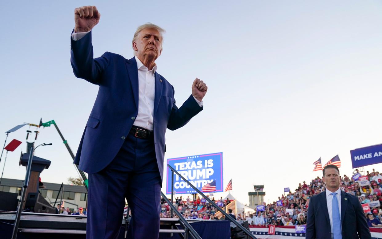 Former president Donald Trump dances during a campaign rally after speaking at Waco Regional Airport - AP