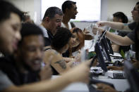 FILE - People buy marijuana products at the Essence cannabis dispensary, Saturday, July 1, 2017, in Las Vegas. Nevada dispensaries were legally allowed to sell recreational marijuana starting at 12:01 a.m., that day. (AP Photo/John Locher, File)