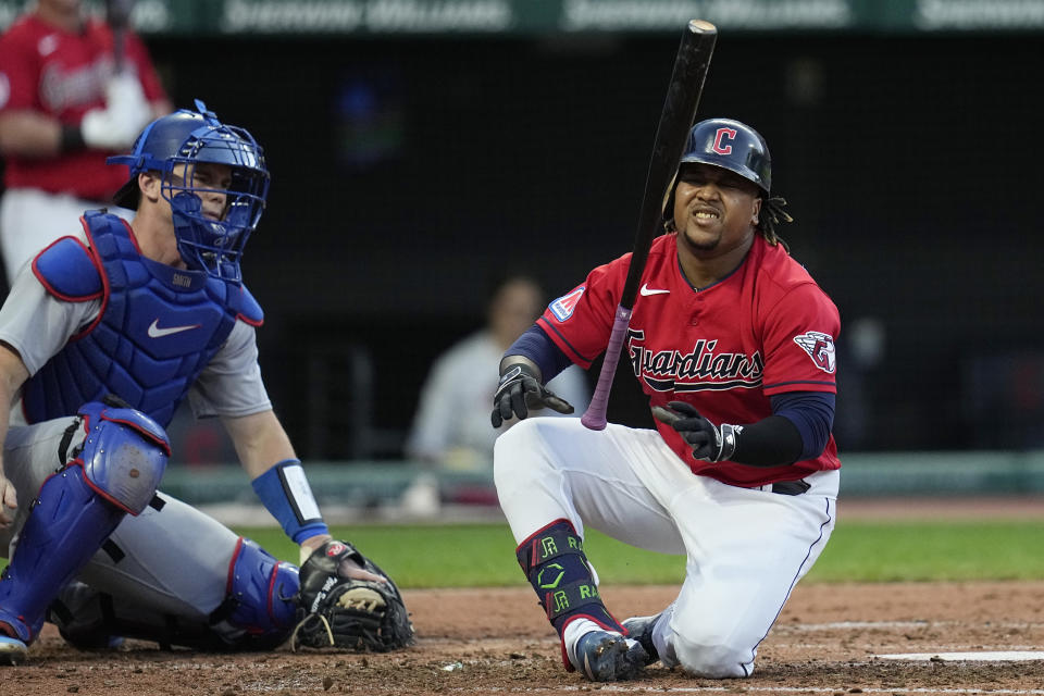 Cleveland Guardians' Jose Ramirez falls in front of Los Angeles Dodgers catcher Will Smith, left, on at-bat during the fourth inning of a baseball game Tuesday, Aug. 22, 2023, in Cleveland. Ramirez remained in the game. (AP Photo/Sue Ogrocki)