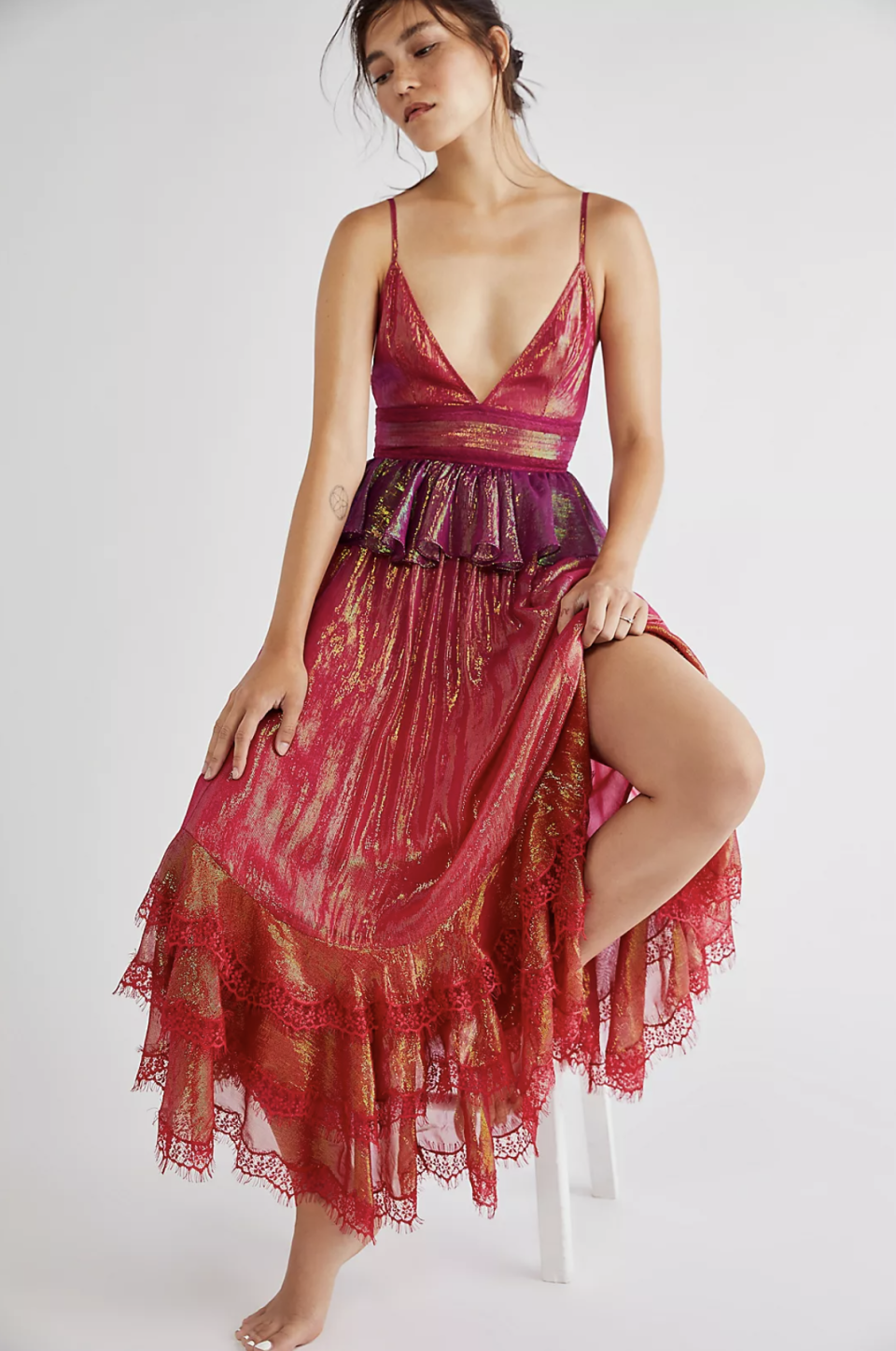 asian model sitting on stool posing in pink lace and shimmer dress with deep v-neck