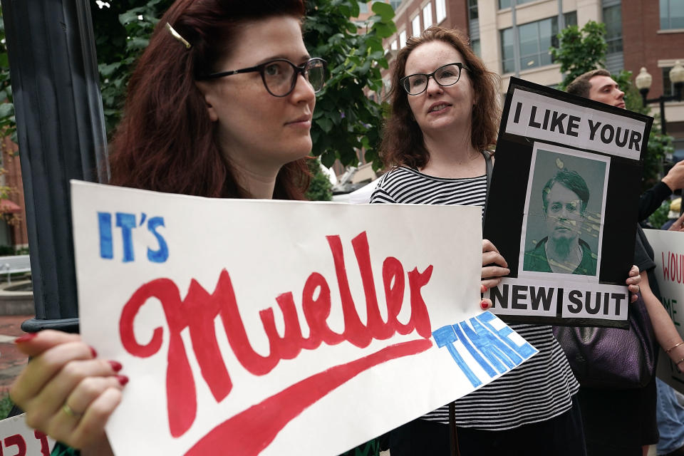 <p>Activists hold signs during a protest outside the Albert V. Bryan United States Courthouse prior to the first day of the trial of former Trump campaign chairman Paul Manafort July 31, 2018 in Alexandria, Va. (Photo: Alex Wong/Getty Images) </p>
