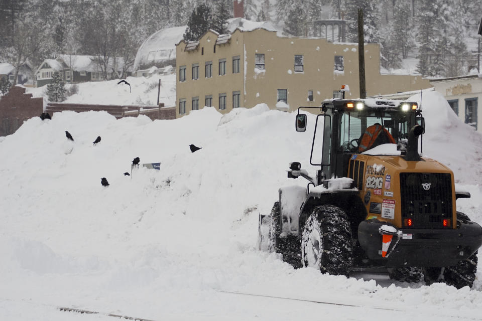 Snow is cleared from a street during a storm, Sunday, March 3, 2024, in Truckee, Calif. (AP Photo/Brooke Hess-Homeier)