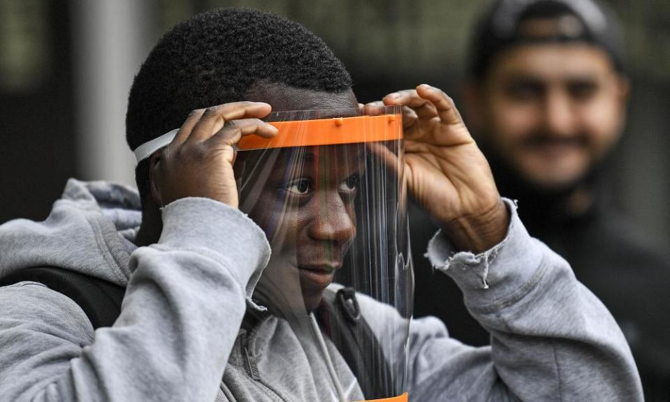 A student tries out a face shield at a school in Cologne