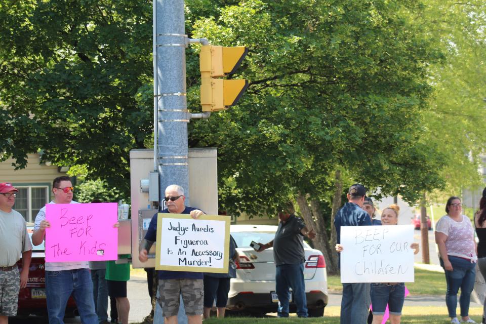 Roughly 20 community members participated in the demonstration outside Magisterial District Judge Aurelis Figueroa's office in Lebanon, Pa., holding signs and encouraging drivers to honk their horns in support June 2, 2023.