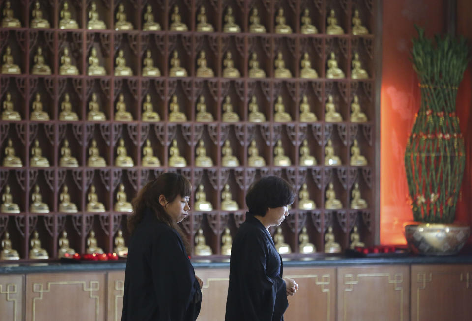 Chinese relatives of passengers on board the missing Malaysia Airlines Flight MH370 walk together after praying at a Buddhist temple in Petaling Jaya, Malaysia, Monday March 31, 2014. Relatives from China are in the country to seek answers of what happened to their loved one on board the plane. (AP Photo/Aaron Favila)