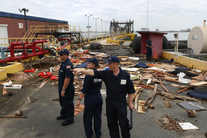 <p>U.S. Coast Guard personnel survey the damage to an oil dock after Hurricane Maria passed through the area on Sept. 23, 2017 in San Juan, Puerto Rico. (Photo: Joe Raedle/Getty Images) </p>