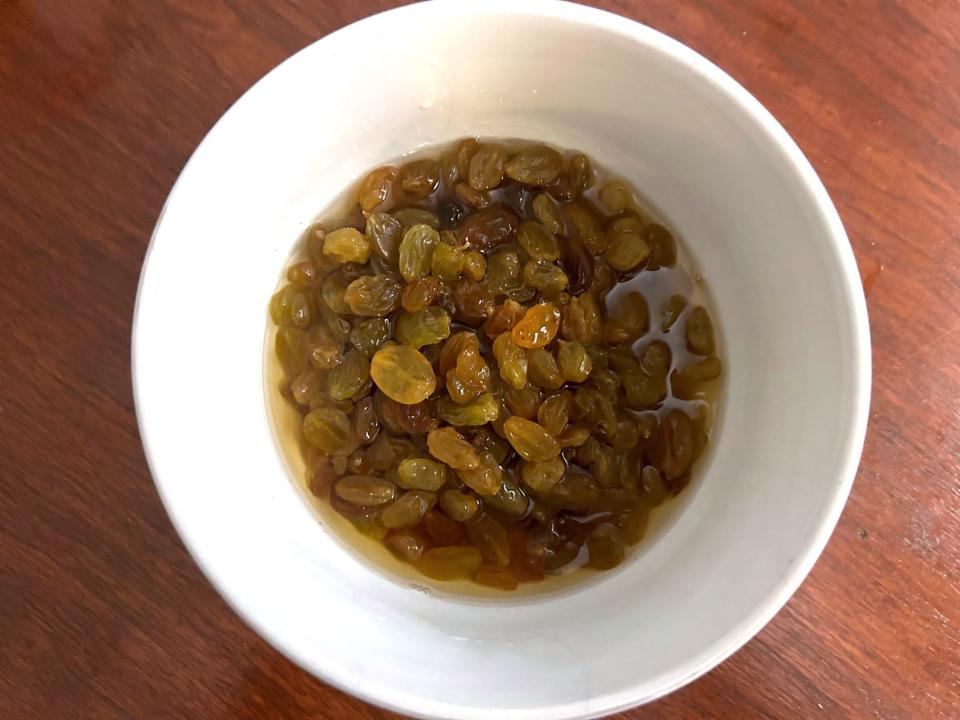 Soaking raisins in rum for Ina Garten's Apple Spice Cake