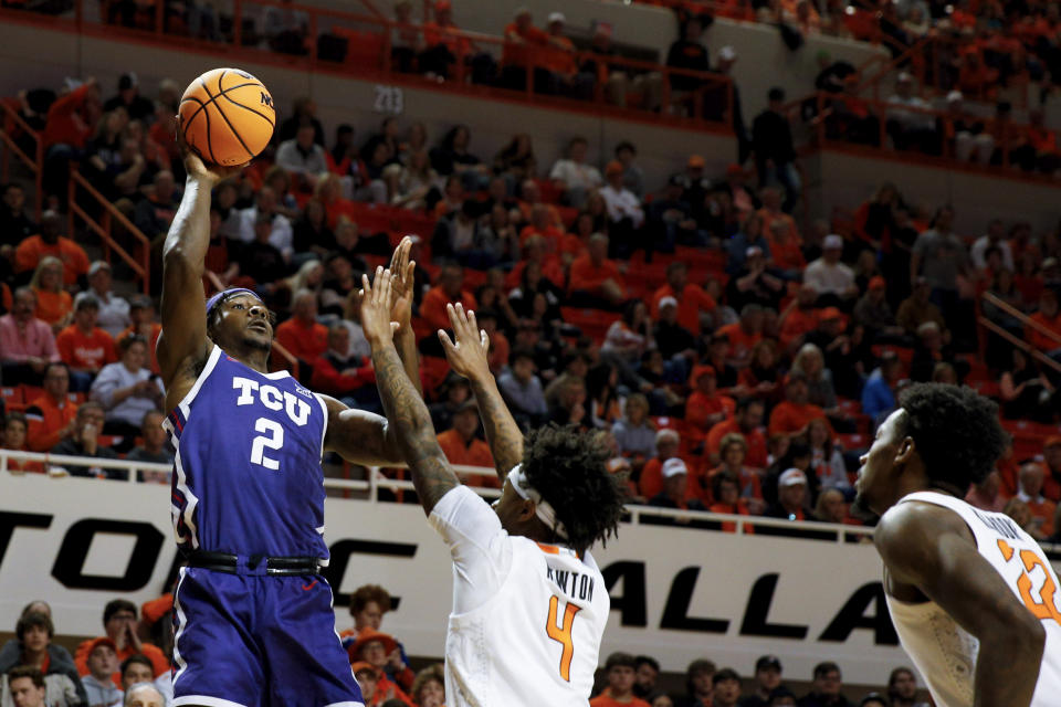 TCU's Emanuel Miller (2) shoots over Oklahoma State's Woody Newton (4) in the second half of an NCAA college basketball game in Stillwater, Okla., Saturday, Feb. 4, 2023. (AP Photo/Mitch Alcala)