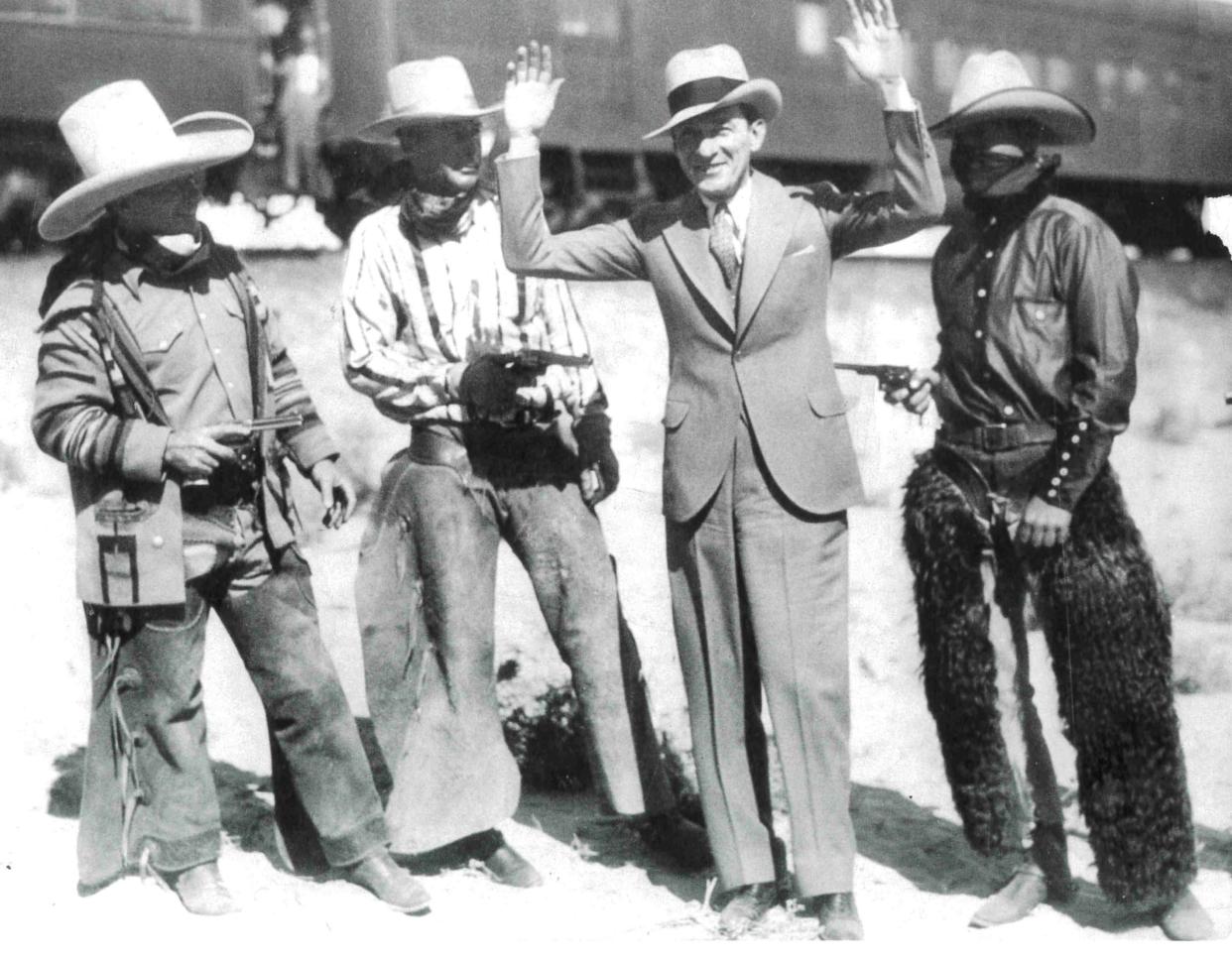 New York City Mayor Jimmy Walker reaches for the sky in March 1931 after being apprehended by Palm Springs cowboy “bandits” on his arrival to town.