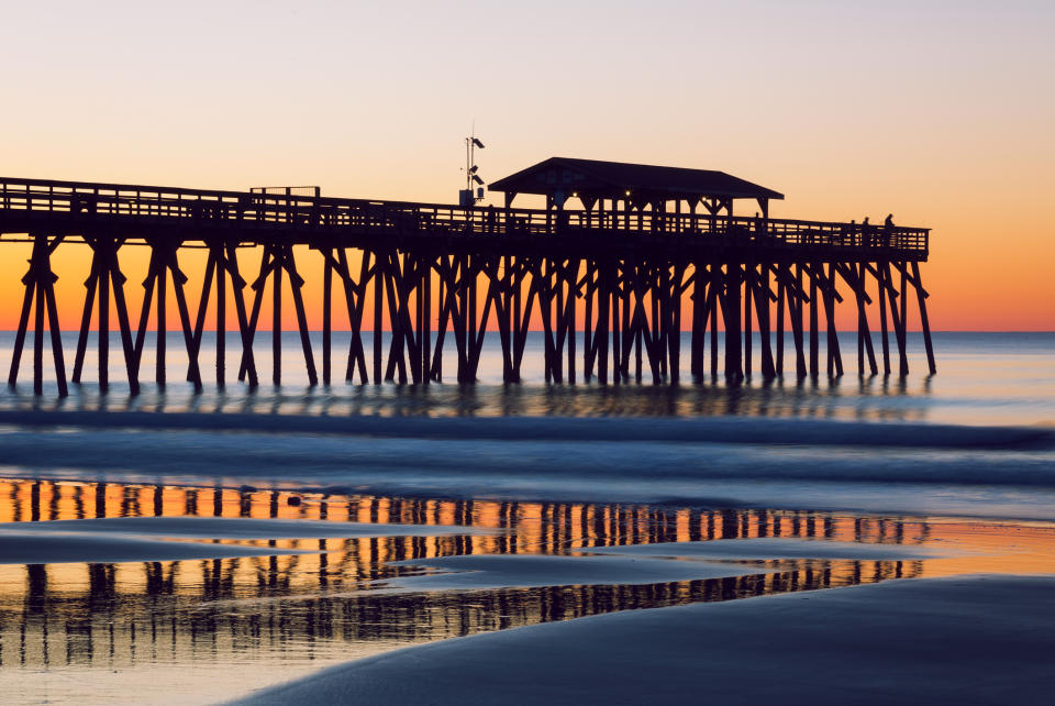 The silhouette of the Myrtle Beach State Park Pier and fisherman during an early morning sunrise on the Atlantic Ocean. (Getty)