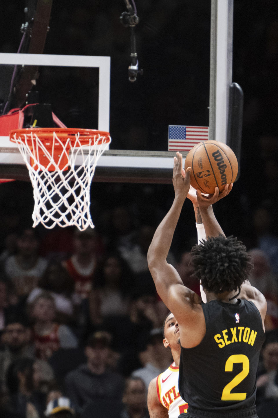 Utah Jazz guard Collin Sexton (2) shoots over Atlanta Hawks guard Dejounte Murray during the second half of an NBA basketball game Tuesday, Feb. 27, 2024, in Atlanta. (AP Photo/Hakim Wright Sr.)