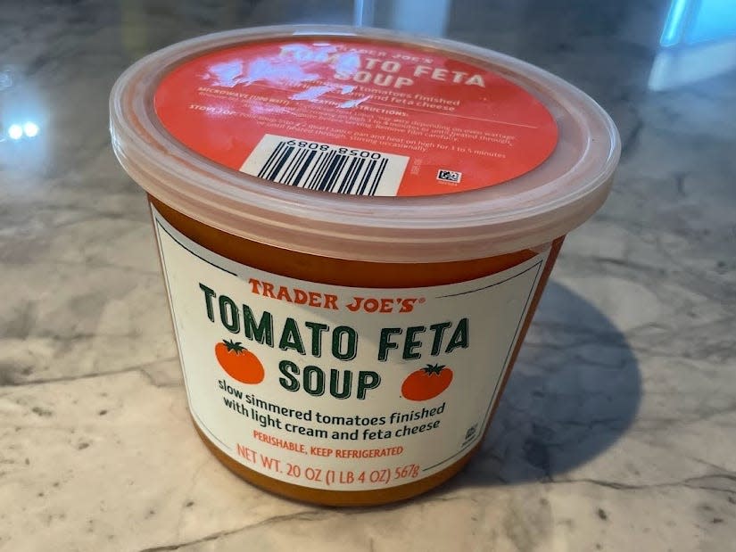 container of trader joe's tomato feta soup on a kitchen counter