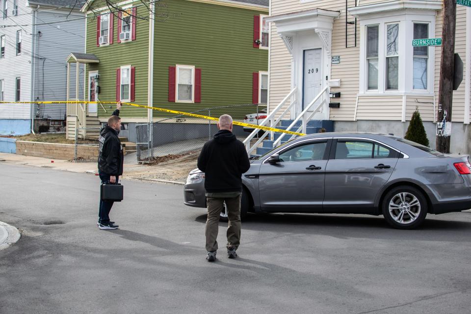 A police car drives onto Burnside Street on Feb. 12 following a fatal shooting at a house.