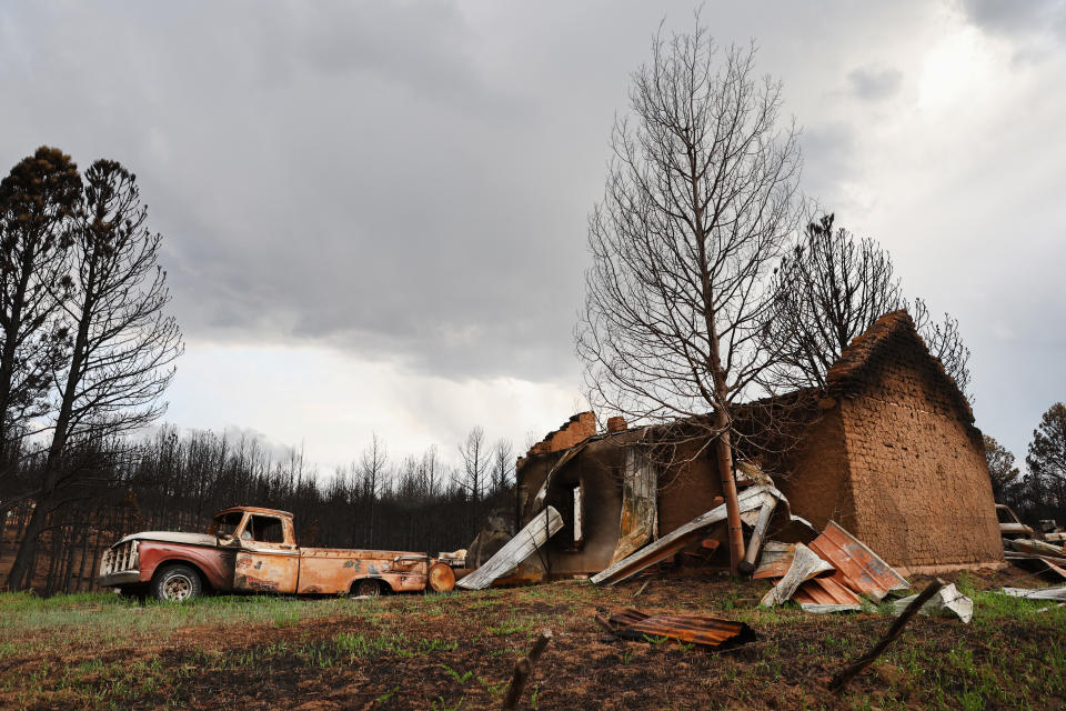 A scorched structure and vehicle stand on a property mostly destroyed by the Hermits Peak/Calf Canyon Fire on June 2, 2022 near Las Vegas, New Mexico. (Mario Tama/Getty Images)