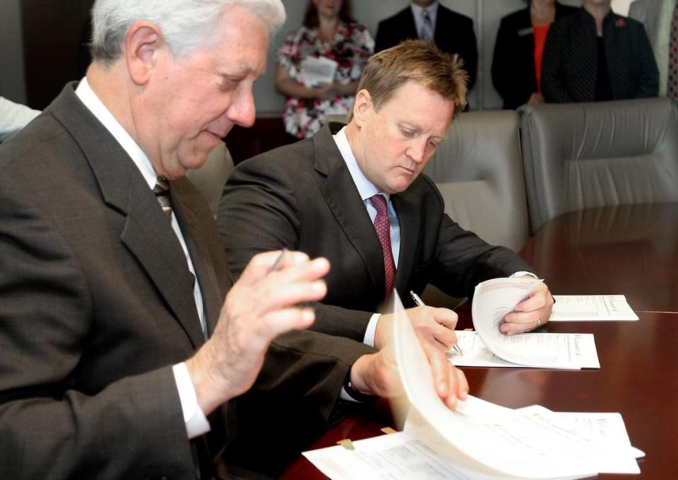 AMANDA McCOY/SUN HERALD Mayor George Schloegel, left, and Roy Anderson sign the construction contract for the building of INFINITY Science Center on Tuesday, April 6 2010.