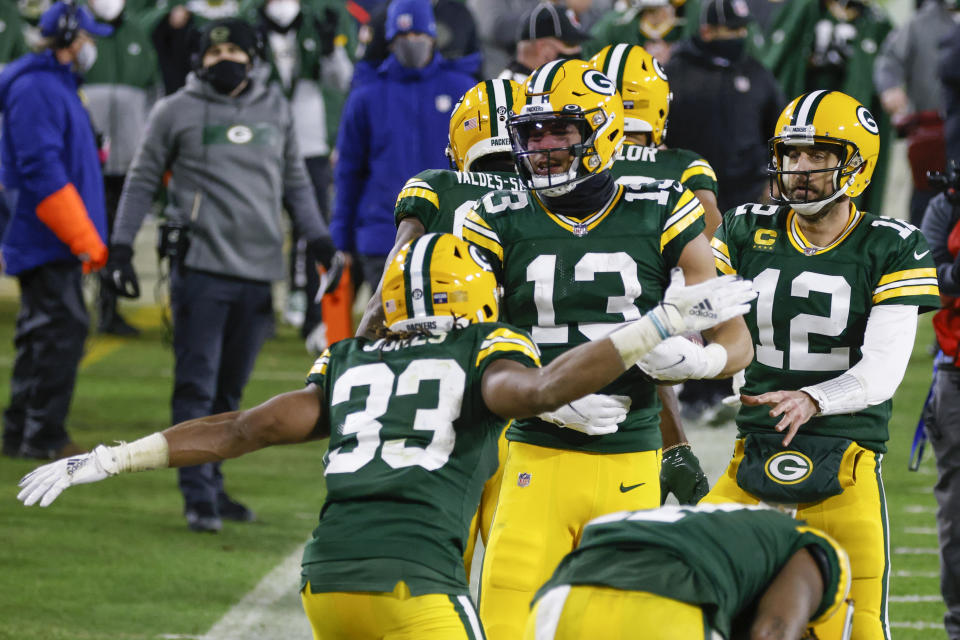 Green Bay Packers' Allen Lazard (13) celebrates after scoring a 58-yard touchdown during the second half of an NFL divisional playoff football game against the Los Angeles Rams Saturday, Jan. 16, 2021, in Green Bay, Wis. (AP Photo/Matt Ludtke)