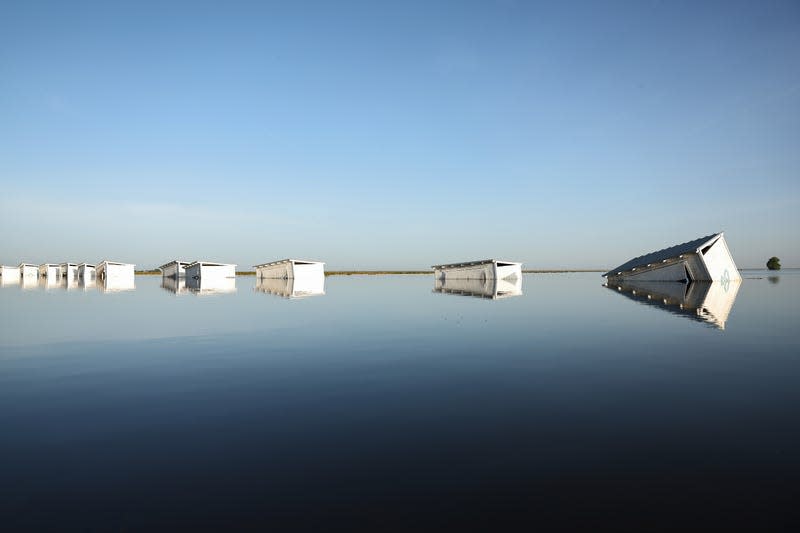 Farm buildings are flooded by water in Tulare Lake on April 26, 2023. 