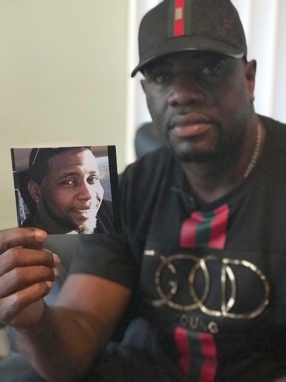 In an Aug. 7, 2018, photo, Michael McGlockton holds a photo of his son, Markeis McGlockton, in Clearwater, Fla. Markeis was shot and killed on July 19 in Clearwater during an argument over a parking spot. The shooter, Michael Drejka, used a “stand your ground” defense, but was convicted of manslaughter.