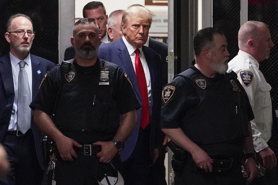Former President Donald Trump is escorted to a courtroom in New York on April 4, 2023. Trump is accused of falsifying internal business records at his private company while trying to cover up an effort to illegally influence the 2016 election by arranging payments that silenced claims potentially harmful to his candidacy. (AP Photo/Mary Altaffer)