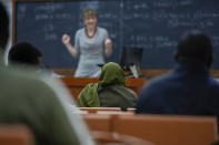 Batool Haidari, 37, center, attends an Italian language class, in Rome, Monday, Dec. 5, 2022. Batool Haidari was a prominent professor of sexology at a university in Kabul before last year’s Taliban takeover of Afghanistan. She used to lecture mixed classes of male and female students and look after her patients struggling with their gender identity. That comfortable life came to an abrupt halt on Aug. 15, 2021, when the ultra-religious group swept back into power. (AP Photo/Andrew Medichini)