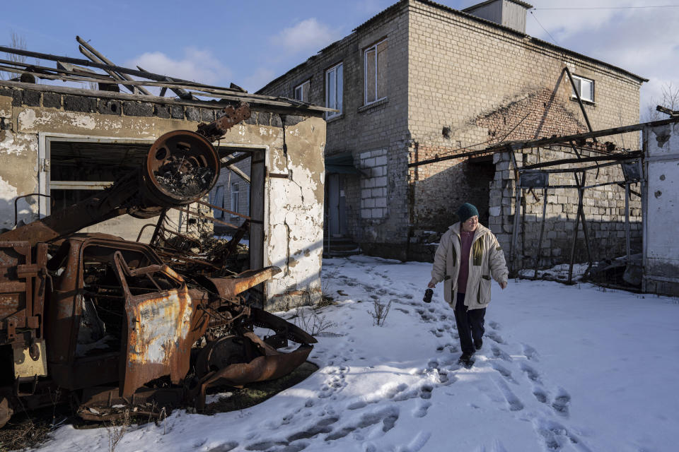 Valentyna Mozgova, 55, lab medic walks in the yard of a hospital which was damaged by Russian shelling in Krasa nohorivka, Ukraine, Sunday, Feb. 19, 2023. (AP Photo/Evgeniy Maloletka)