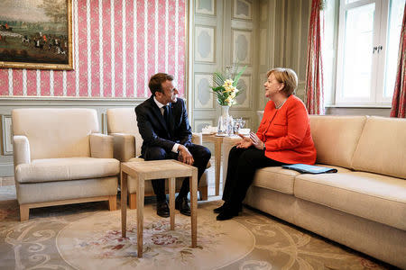 German Chancellor Angela Merkel and French President Emmanuel Macron attend a bilateral meeting at the German government guesthouse Meseberg Palace in Meseberg, Germany, June 19, 2018. Bundesregierung/Jesco Denzel/Handout via REUTERS ATTENTION EDITORS - THIS PICTURE WAS PROVIDED BY A THIRD PARTY. NO RESALES. NO ARCHIVE.