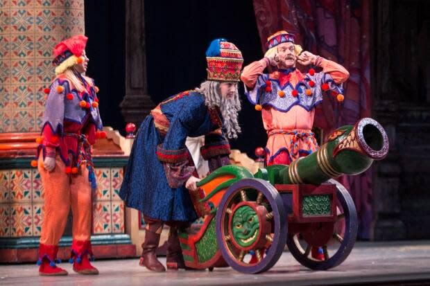 Canadian astronaut Chris Hadfield, right, and dancer Julia Ostrowski, left, appear as cannon dolls, with dancer Trygve Cumpston, centre, in the National Ballet of Canada's production of the The Nutcracker in Toronto on Dec. 24, 2013. (Chris Young/The Canadian Press - image credit)