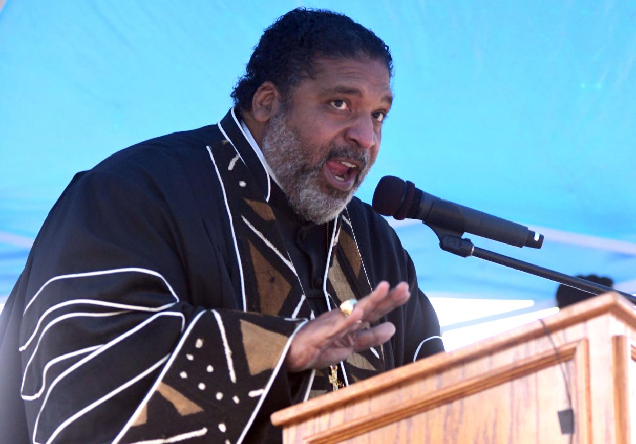 Rev. William Barber performed the service for Joshua Halsey at Pine Forest Cemetery in Wilmington, N.C., Saturday, November 6, 2021. Halsey was one of many Black people who were killed in Wilmington during the 1898 massacre. The event was one of several organized by New Hanover County and the City of Wilmington to commemorate the 123rd anniversary of the massacre.   [MATT BORN/STARNEWS]