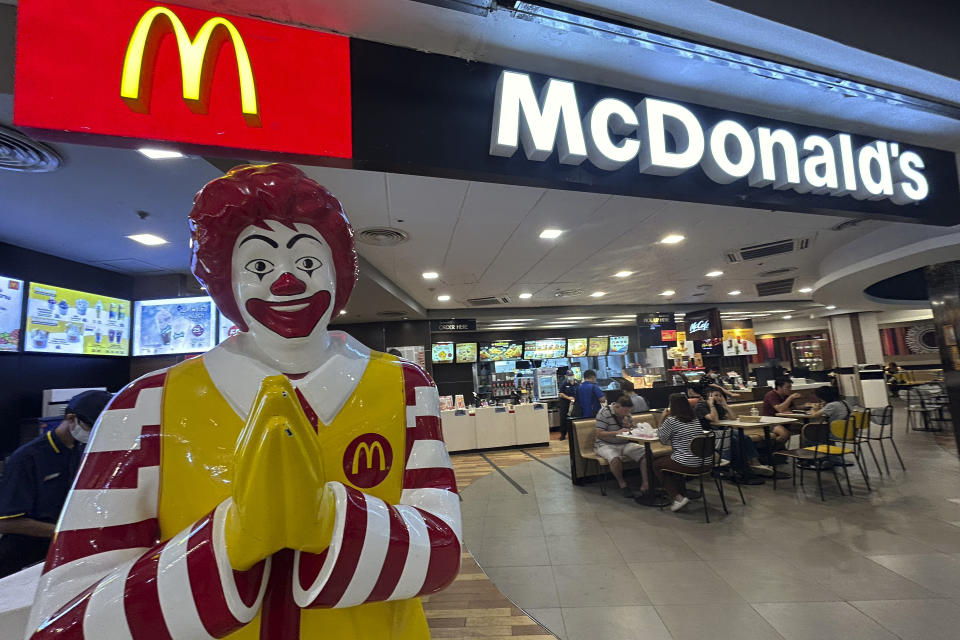 Thai people enjoy a meal at McDonald's at a shopping mall in Bangkok, Thailand, Friday, March 15, 2024. On a Facebook page of McDonald's Thailand, a few customers left comments complaining that they were unable to redeem a promotion coupon at stores around 1-2pm local time. The page replied that they were working on fixing problems and apologizing for the inconvenience. About an hour later, the page replied again that the application was up and running again. (AP Photo/Sakchai Lalit)