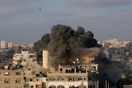 A missile lands as an Israeli aircraft bombs a building in Gaza City August 9, 2018. REUTERS/Mohammed Salem