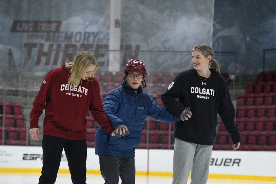 Danielle Serdachny, right, and Colgate University ice hockey teammate Kaitlyn O'Donohoe help a resident of Pathfinder Village during an inclusive learn-to-skate program on Jan. 17, 2024.
