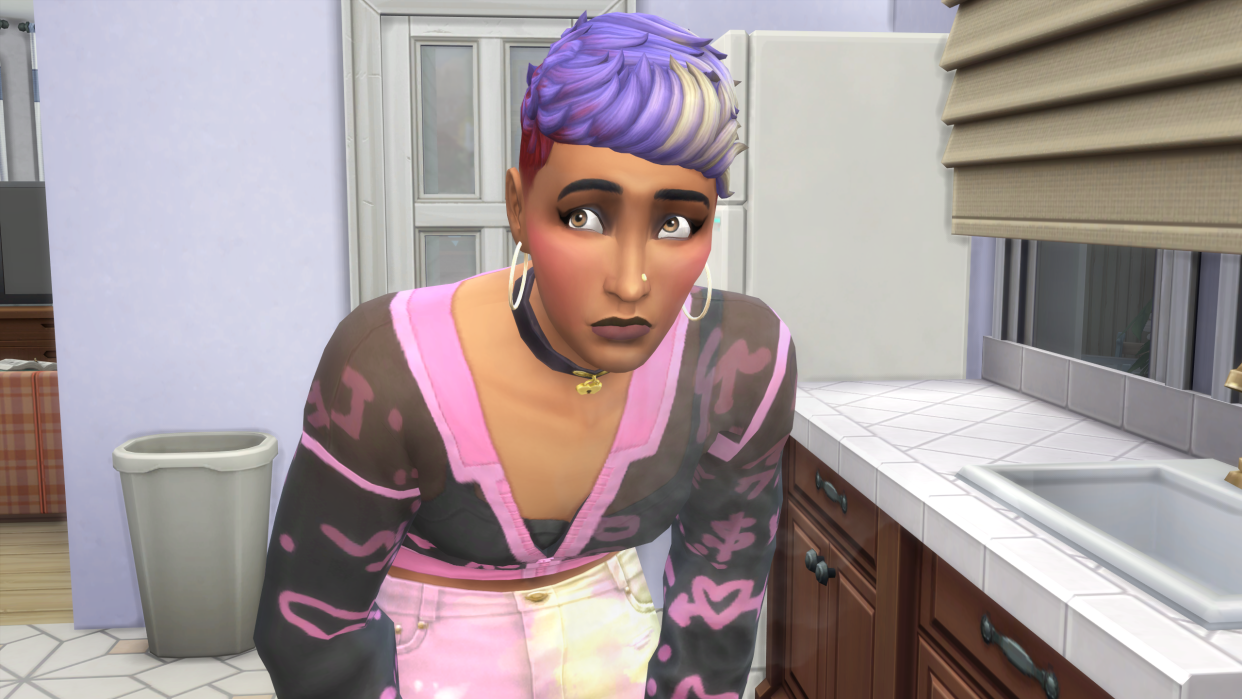  The Sims 4 - a sim with purple hair wearing a cardigan hunches over a kitchen stove looking nervous. 