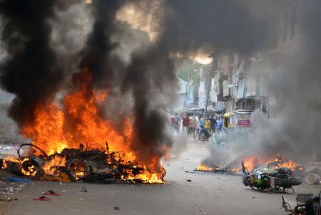 Motorcycles burn after they were set on fire by a mob during a clash in Vadodara, September 25, 2014. REUTERS/Stringer/Files