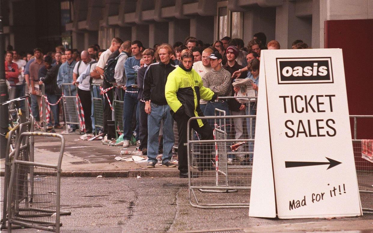 Hundreds of Oasis fans, many of whom had slept rough overnight in order to ensure a place in the queue, patiently wait for the ticket office to open at Olympia in London in 1997