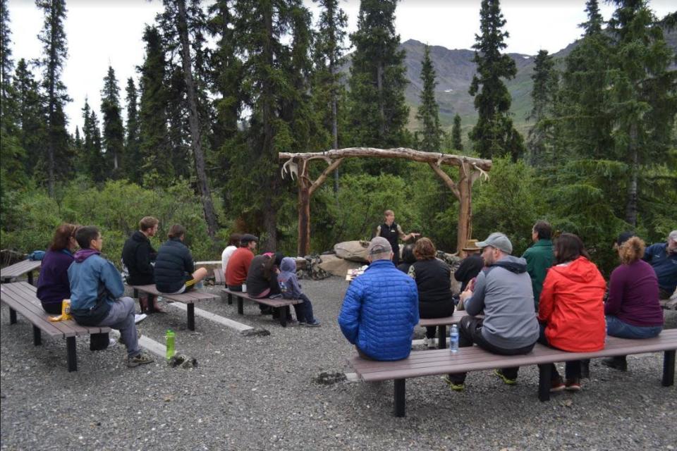 Visitors listen to a talk by staff at Tombstone Territorial Park.