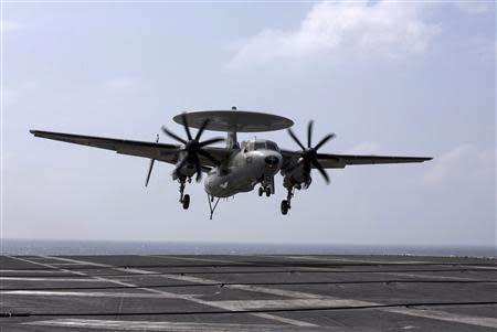 A U.S. Navy Northrop Grumman E-2 Hawkeye prepares to land on the runway of the U.S. Navy aircraft carrier USS George Washington, during a tour of the ship in the South China Sea November 7, 2013. REUTERS/Tyrone Siu