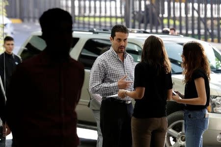 A job seeker (C) talks to a recruiter from Tesla (2nd R) at the hotel where the electric vehicle maker is holding a recruiting event for its California factory, in the municipality of San Pedro Garza, neighbouring Monterrey, May 5, 2017. REUTERS/Daniel Becerril