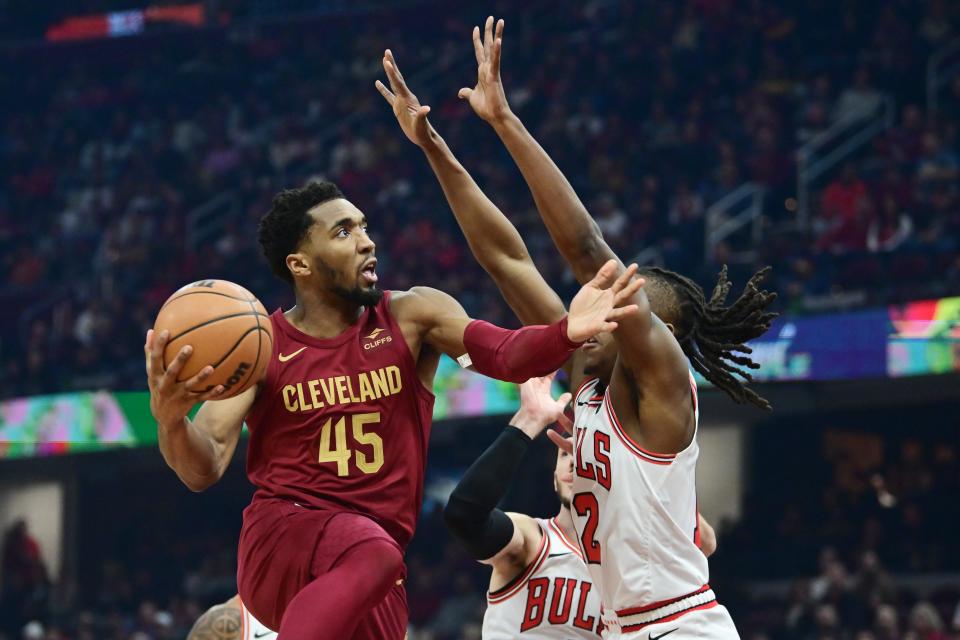 Feb 14, 2024; Cleveland, Ohio, USA; Cleveland Cavaliers guard Donovan Mitchell (45) drives to the basket against Chicago Bulls guard Ayo Dosunmu (12) during the first half at Rocket Mortgage FieldHouse. Mandatory Credit: Ken Blaze-USA TODAY Sports