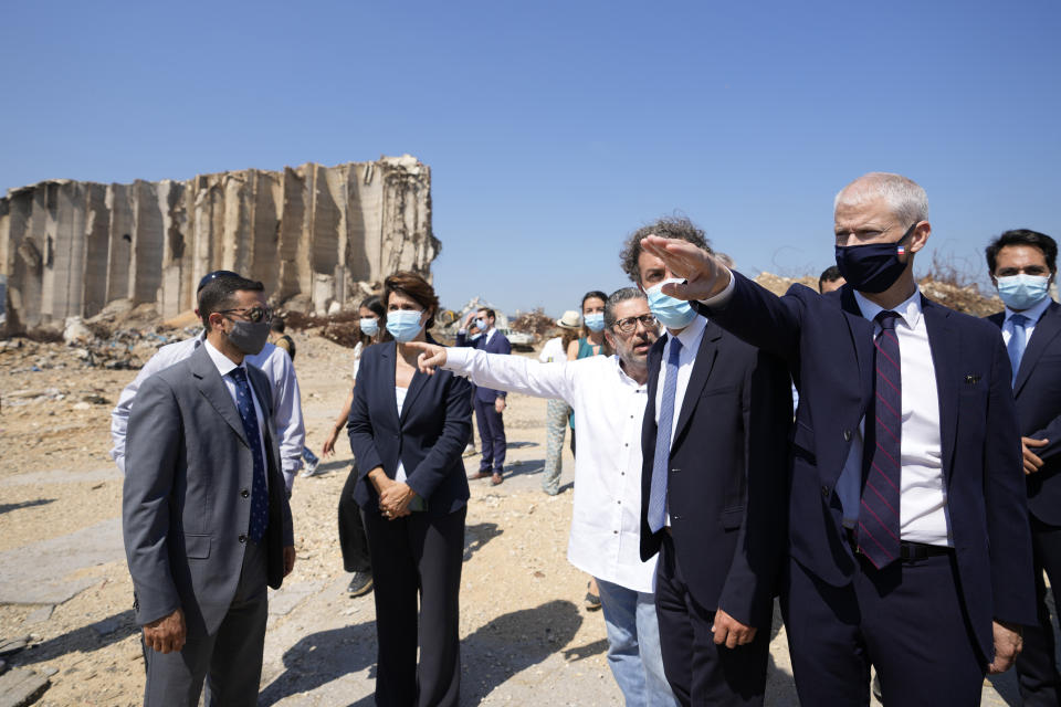 French Foreign Trade Minister Franck Riester, second right, visits Beirut's port, devastated in a massive deadly explosion in August last year, in Beirut, Lebanon, Tuesday, July 13, 2021. Riestert criticized Lebanese leaders on Tuesday, warning them of upcoming sanctions from Paris that will target Lebanese officials blocking the formation of a new government. (AP Photo/Hassan Ammar)