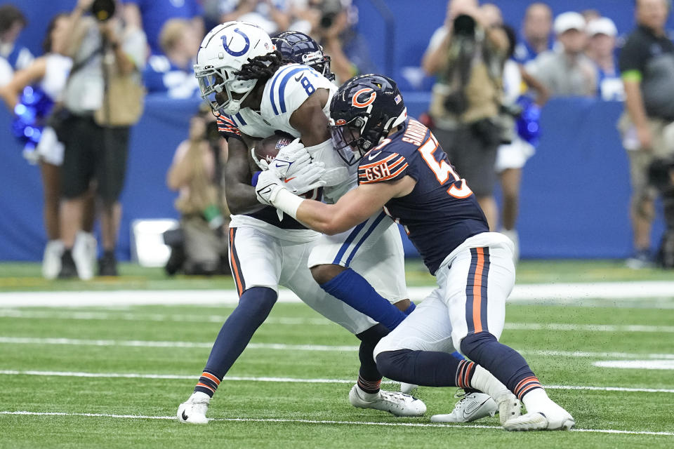 Indianapolis Colts wide receiver Juwann Winfree (8) is tackled by Chicago Bears defenders Jack Sanborn, right, and Tyrique Stevenson, back, during the first half of an NFL preseason football game in Indianapolis, Saturday, Aug. 19, 2023. (AP Photo/Darron Cummings)