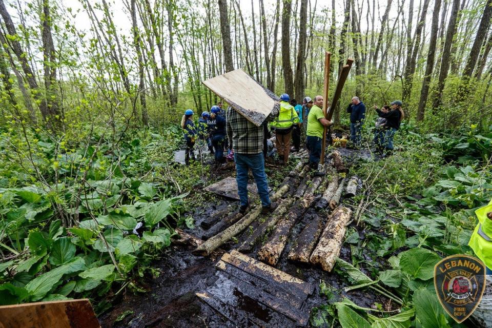 Plywood, logs, cribbing and sings were all used to create a makeshift bridge through the mud (LVFD)